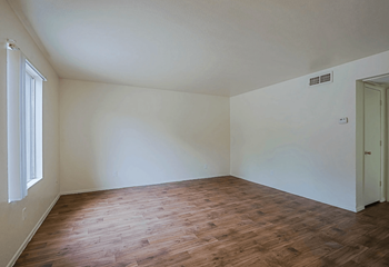 A room with wooden floors and white walls at Sahuaro West, Arizona 85029
